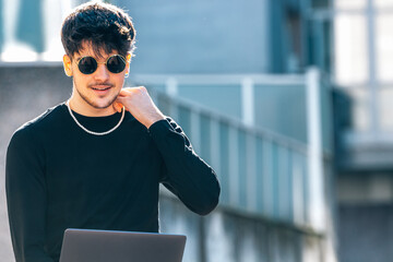 Wall Mural - young man in the street with laptop