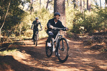 Forest, Fitness And Friends Cyclist On Bicycle In Nature With Helmet, Exercise Adventure Trail And Health Mindset. Cycling, Woods And Man With Mountain Bike In Trees For Workout, Motivation Or Energy