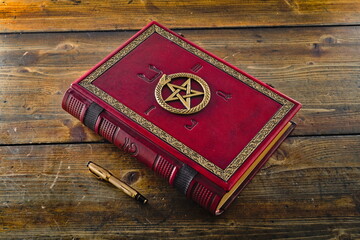 Wall Mural - Red leather book with Ouroboros, pentagram and ancient Egyptian Symbols, lay down to wooden table