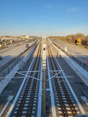 Poster - Aerial view of long railways with two asphalt roads on each side in sunny weather