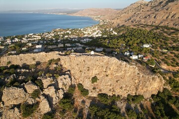 Aerial view of a town on the rocky shore with a blue sky in the background, Rhodes, Greece