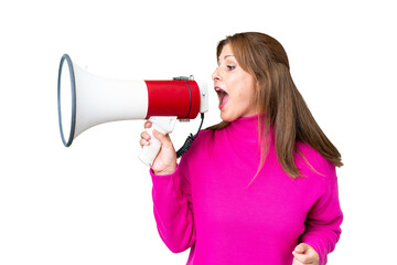 Canvas Print - Middle age woman over isolated background shouting through a megaphone to announce something in lateral position