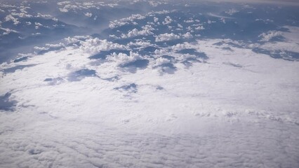 Poster - Aerial view of breathtaking landscapes covered with dense white clouds stretching to the horizon