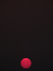 Wall Mural - red sun of sunset on black sky background