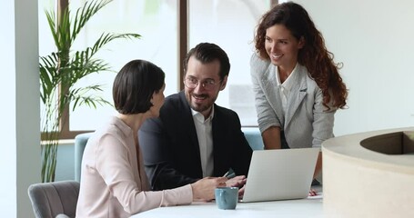 Wall Mural - Happy coworkers discussing online business project, professional app, software product, watching discussing presentation, talking, speaking, brainstorming, using laptop together, smiling, laughing