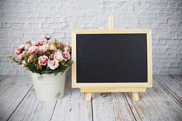 Canvas Print - Empty chalk board and alarm clock on wooden background