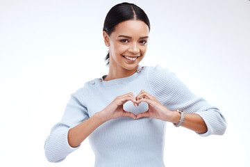 Wall Mural - Portrait, heart and hand gesture with a woman on a white background isolated in studio for health or love. Face, hands and emoji with an attractive young female indoor for romance or valentines day