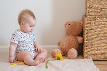 Toddler Baby Plays With A Yellow Gerber Flower