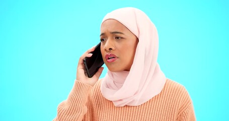 Wall Mural - Muslim woman, phone call and angry, argument or conflict in studio isolated on a blue background mockup. Cellphone, discussion and frustrated Islamic person talking, upset and speaking or question.