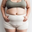 © Patrizia Paradiso - Overweight woman showing belly against neutral background, ai generated