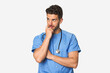 © Asier - Young nurse man relaxed thinking about something looking at a copy space.