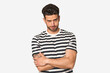 © Asier - Young handsome man isolated unhappy looking in camera with sarcastic expression.