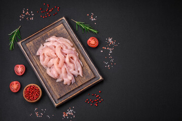 Wall Mural - Raw chicken fillet cut into strips with spices and herbs