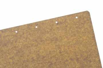 Sticker - brown paper sheet with small holes on a white backlit surface