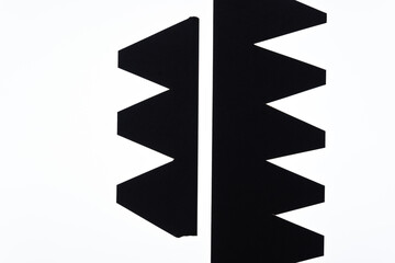 Wall Mural - black paper shapes with arrow or zig zag pattern on a white background