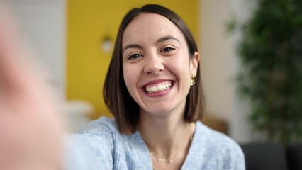 Poster - Young beautiful hispanic woman having video call sitting on sofa at home