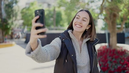 Sticker - Young beautiful hispanic woman smiling confident making selfie by the smartphone at park