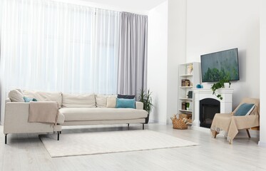 Poster - stylish living room interior with cozy sofa, tv set and fireplace