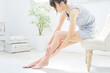 © siro46 - ふくらはぎのスキンケアをする若い女性