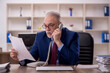 © Elnur - Old male employee working in the office