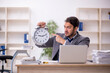 © Elnur - Young male employee in time management concept