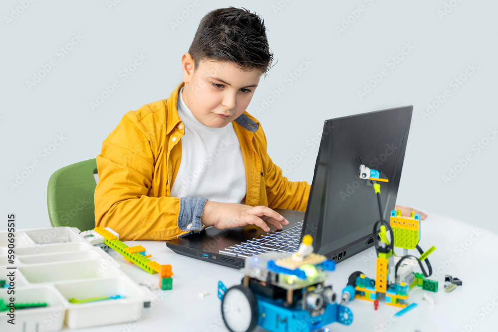 Robotics programming class. Children construct and code Robot. STEM ...