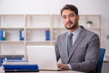 Young male employee working in the office