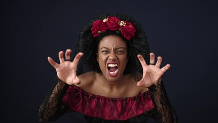 Canvas Print - African american woman wearing katrina costume standing with scare expression over isolated black background