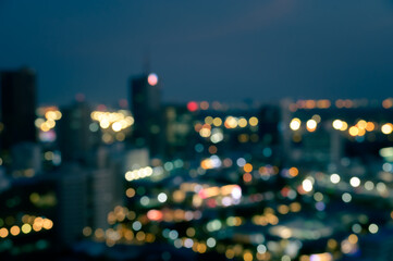 Wall Mural - Blurred bokeh lights city office building, abstract background.