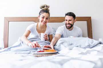 Wall Mural - latin couple having breakfast in bed at home in Mexico, hispanic people	