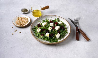 Salad of arugula and beets, pine nuts and with cheese. Vegetarian ideas fo cooking food