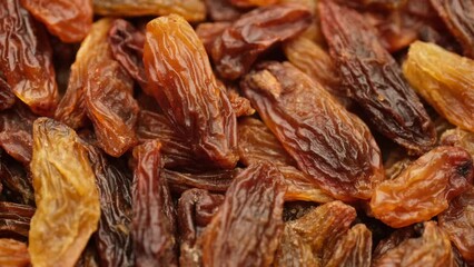 Wall Mural - Raisin dried grape berries macro, rotation. Raisin ingredient in culinary cooking 