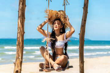 Wall Mural - Asian tourist woman in orange bikini on the beach