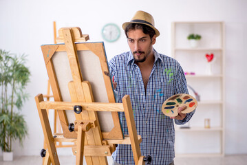 Canvas Print - Young man enjoying painting at the studio