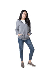 Wall Mural - Full length portrait of young beautiful Asian woman in hoodie sweatshirt and blue jeans isolated over white background