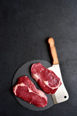 Poster - Raw organic rib eye steak with ingredients for making. Top view with copy space.