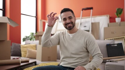 Sticker - Young hispanic man smiling confident holding key at new home