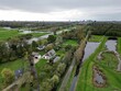 Aerial view over rural houses with trees and canals in Veenendaal, Utrecht Netherlands