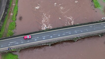 Canvas Print - Aerial shot of the cars driving on the Usk bridge over the river