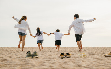 Wall Mural - Father, mother and kids take off shoes run on sand beach, Back view of family parents with children fun holding hands together running to beach in holiday, Travel, active lifestyle, Happy family day