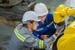 © BESTIMAGE - Two engineer in uniform helmet inspection check control heavy machine robot arm construction installation in industrial factory. technician worker check for repair maintenance electronic operation