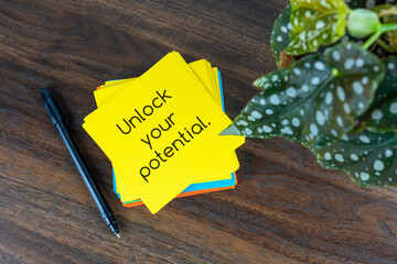 Wall Mural - Yellow paper note with text - Unlock your potential