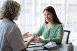 © NINENII - female therapist consulting women patient about pills. Doctor prescribing medicine sitting at the desk.
