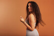 © Flamingo Images - Young black woman posing in underwear on an orange backdrop