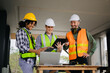 © Nuttapong punna - Engineer teams meeting working together wear worker helmets hardhat on construction site in city. industry professional team.
