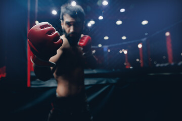 Wall Mural - Portrait man MMA fighter on octagon ring. Fighting Championship, dark background