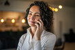 © Miljan Živković - One woman mature caucasian female businesswoman entrepreneur stand at work or home use mobile phone making a call talk real people copy space wear white shirt curly hair happy smile