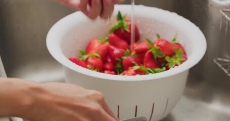 Poster - Wash strawberry in kitchen at home