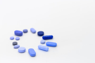 Wall Mural - Assorted pills on a neutral background with light blue colors. Concept of pills used for male erection.