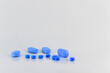 Assorted pills on a neutral background with light blue colors. Concept of pills used for male erection.